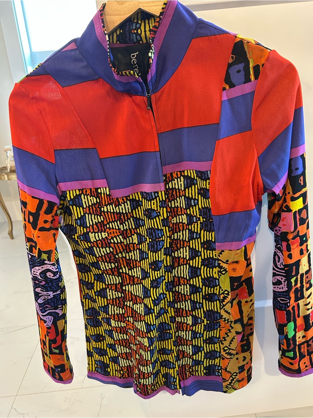 berek Multicolor Printed front zip top with Black Base. Size M